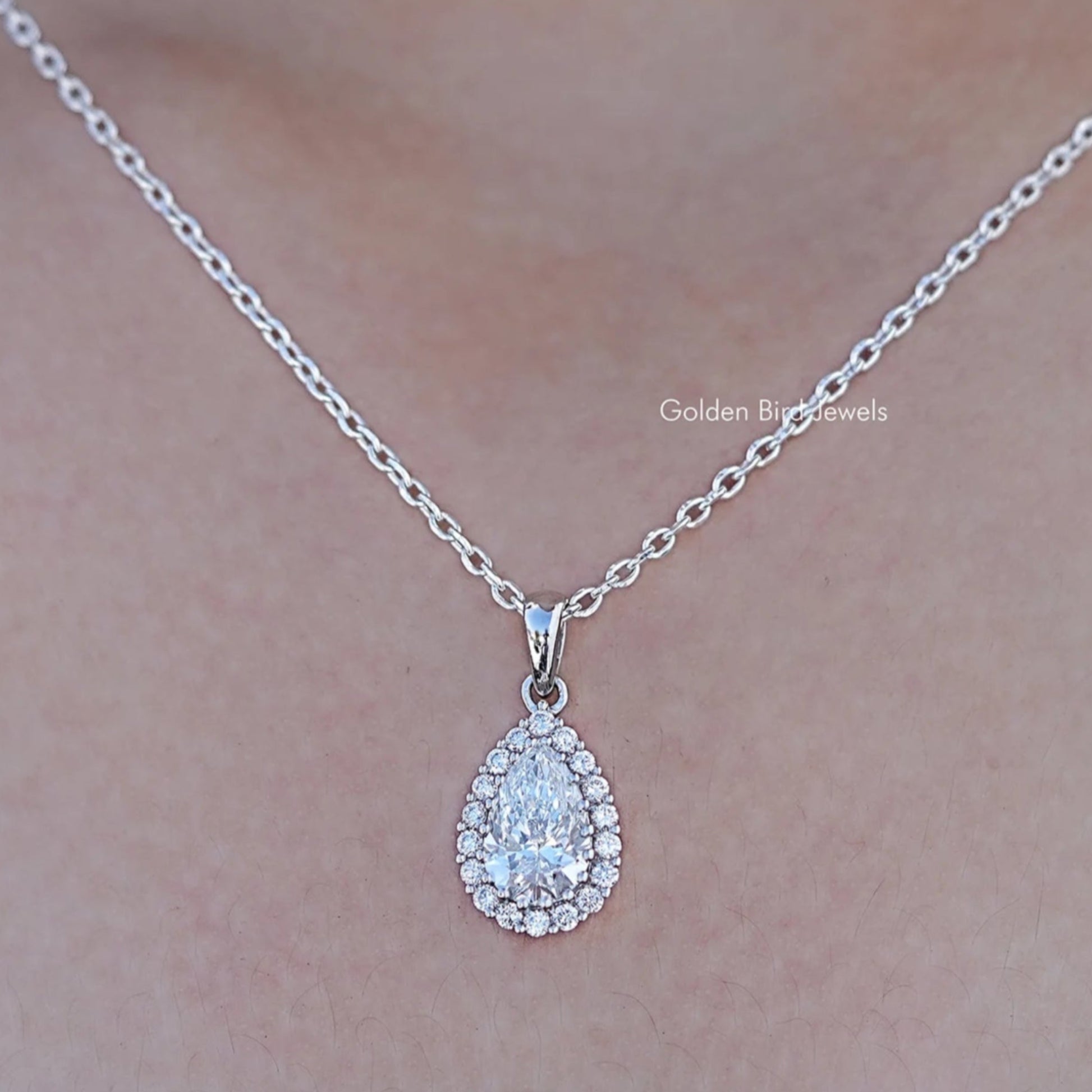 Close up view of Lab Grown Pear Cut Halo Pendant In White Gold