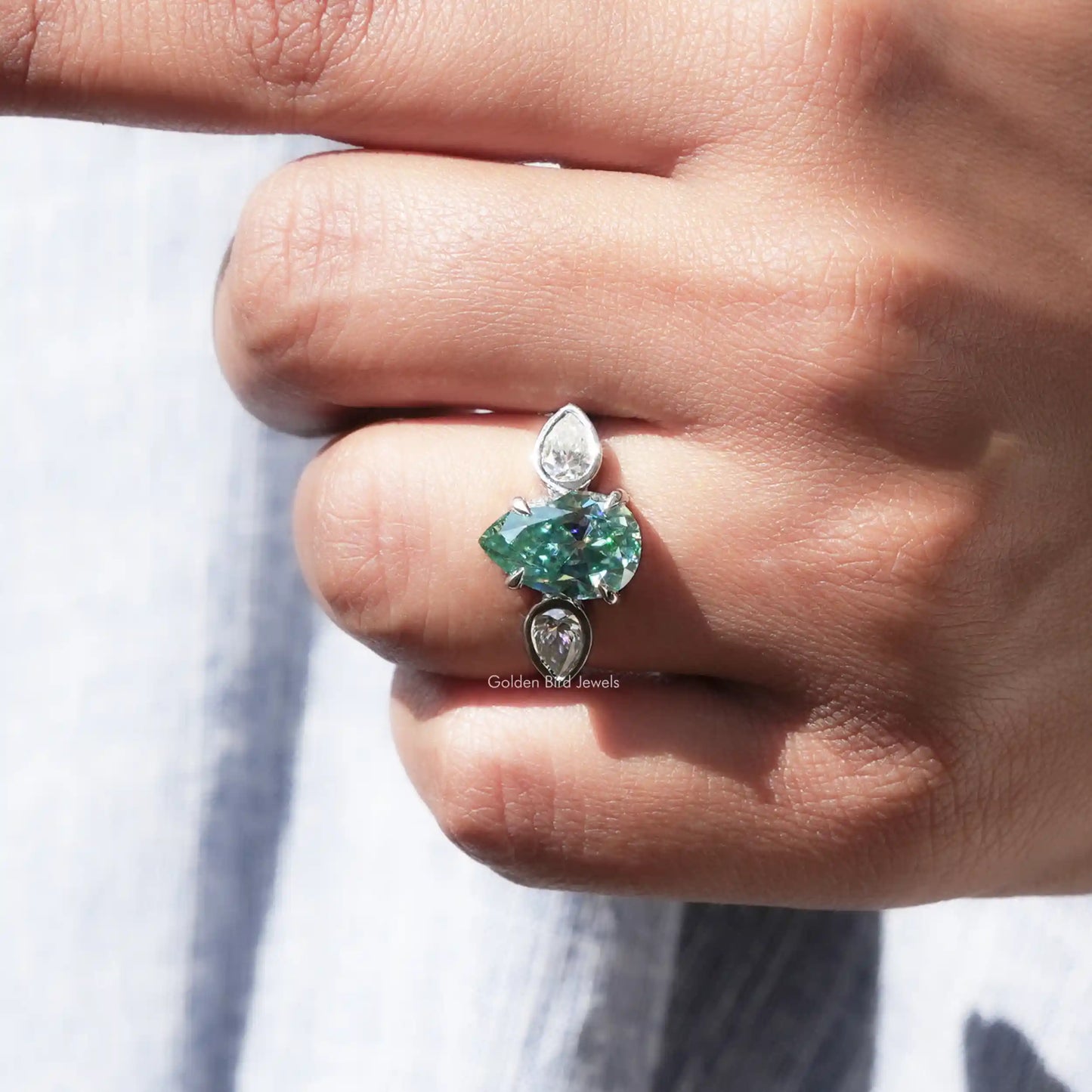 View of Pear Cut Moissanite Three Stone Ring In finger