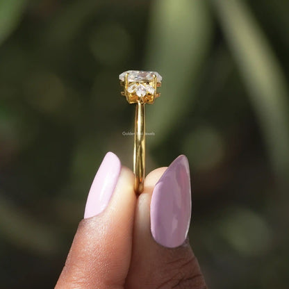 Side View of Pear And Marquise Cut Moissanite Ring In two fingers