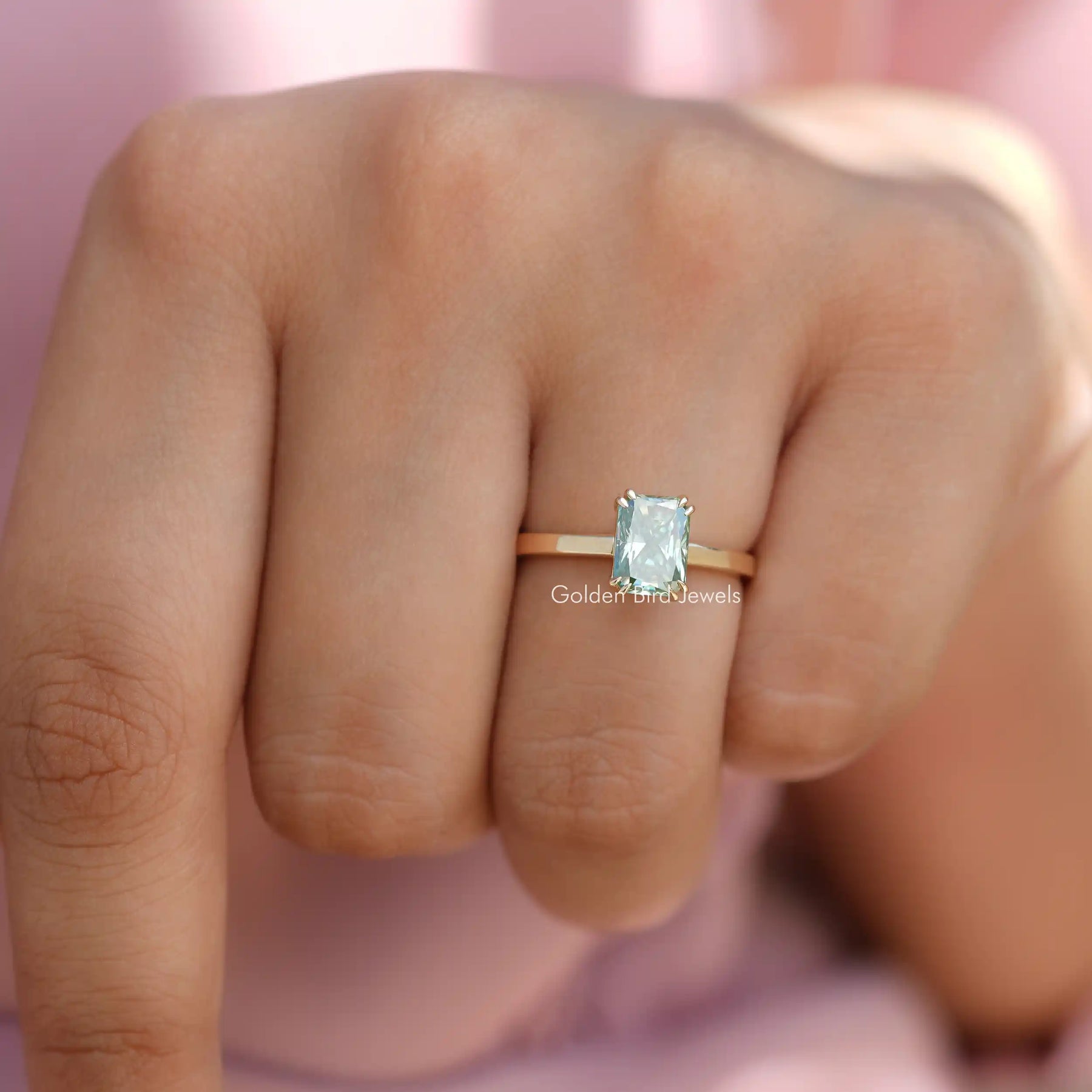 Full View of Blue Radiant Cut Solitare Engagement Ring in a Yellow Gold