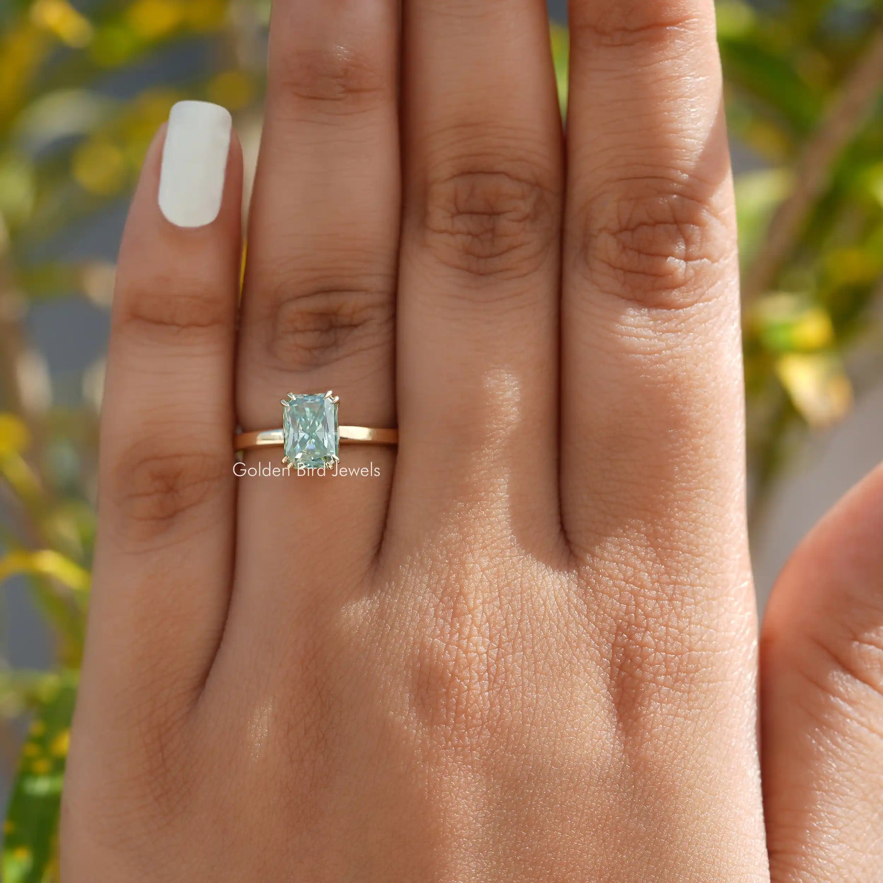 Close-Up View of Radiant Cut Moissanite Solitare Engagement Ring In a finger 