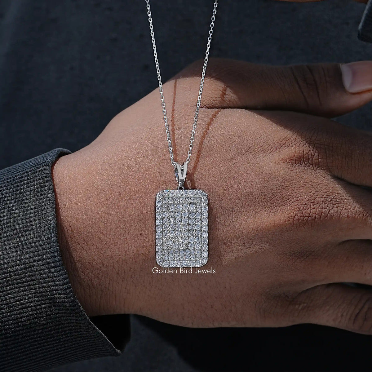 Square lab diamond pendant on silver chain, angled on wrist and arm