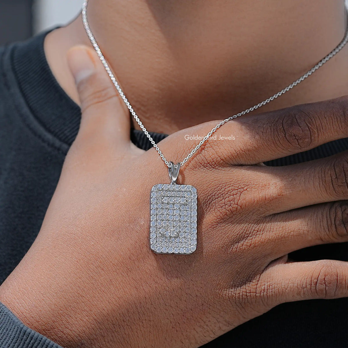 Square lab diamond pendant on silver chain, worn by hand and chest