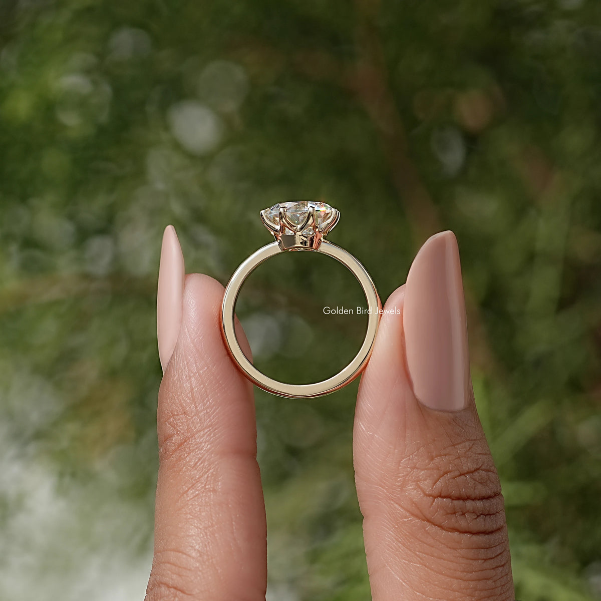 Moissanite solitaire ring viewed from front with prong-set round center stone