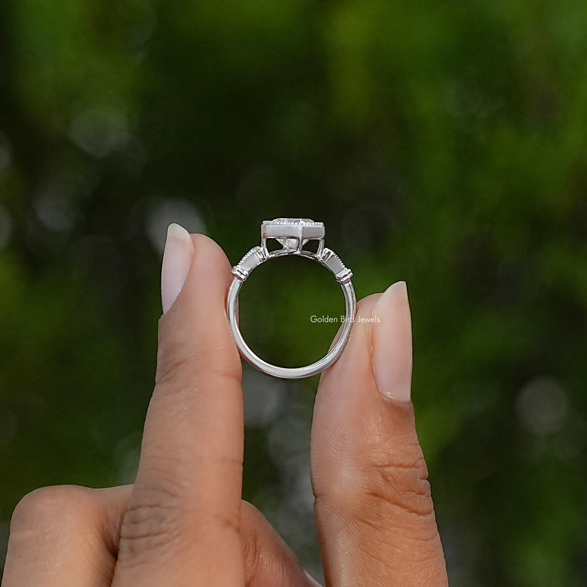 Side view of sterling silver ring showing raised stone setting and detailed shoulders