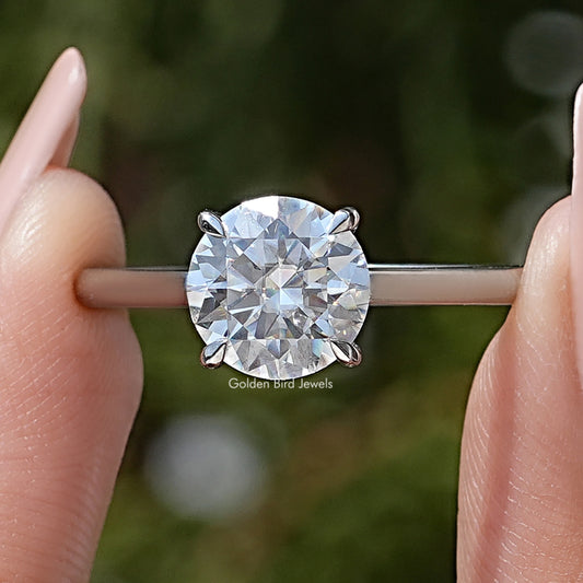 Round solitaire engagement ring with large clear center moissanite and thin metal band
