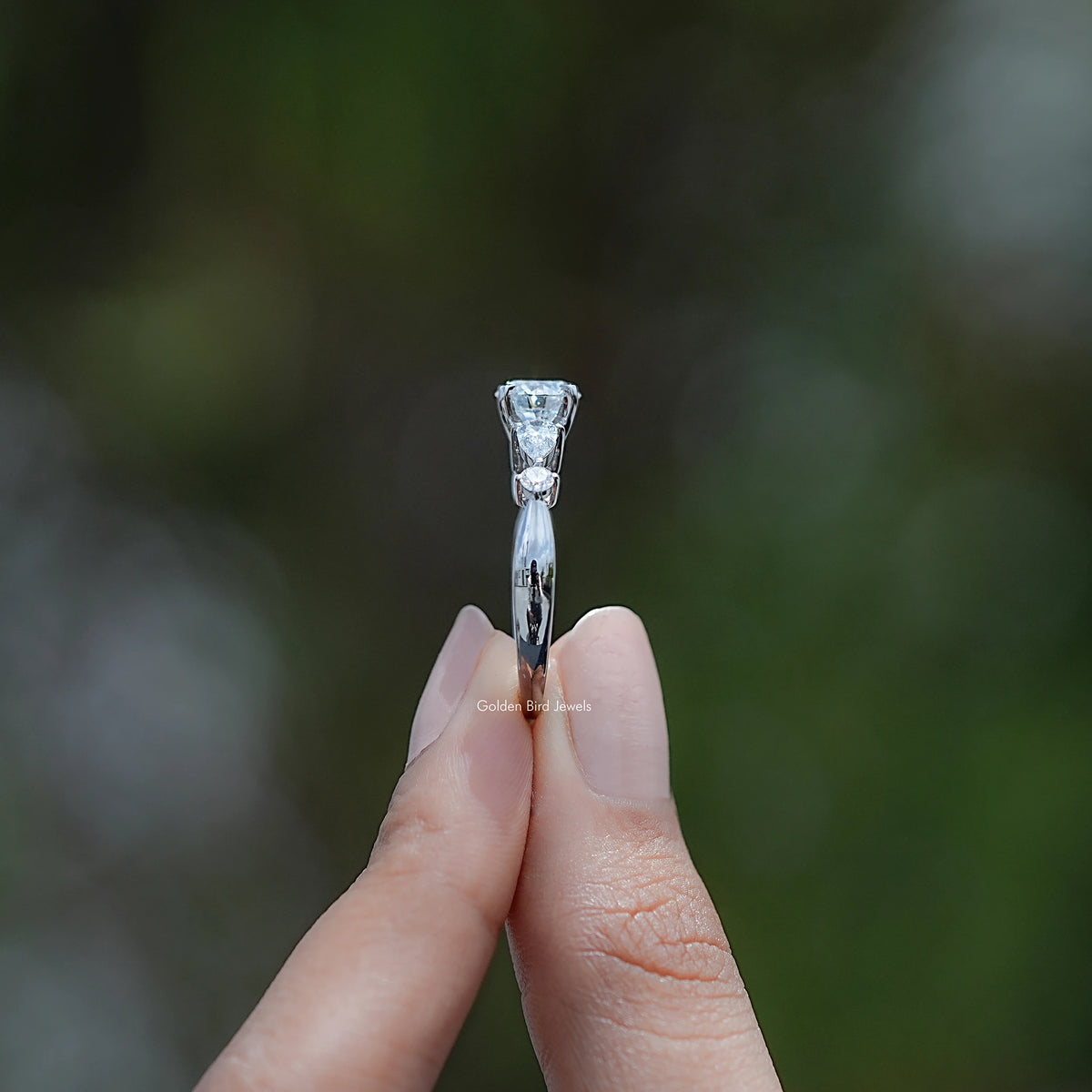 Side View of Round And Pear Cut Diamond Five Stone Ring