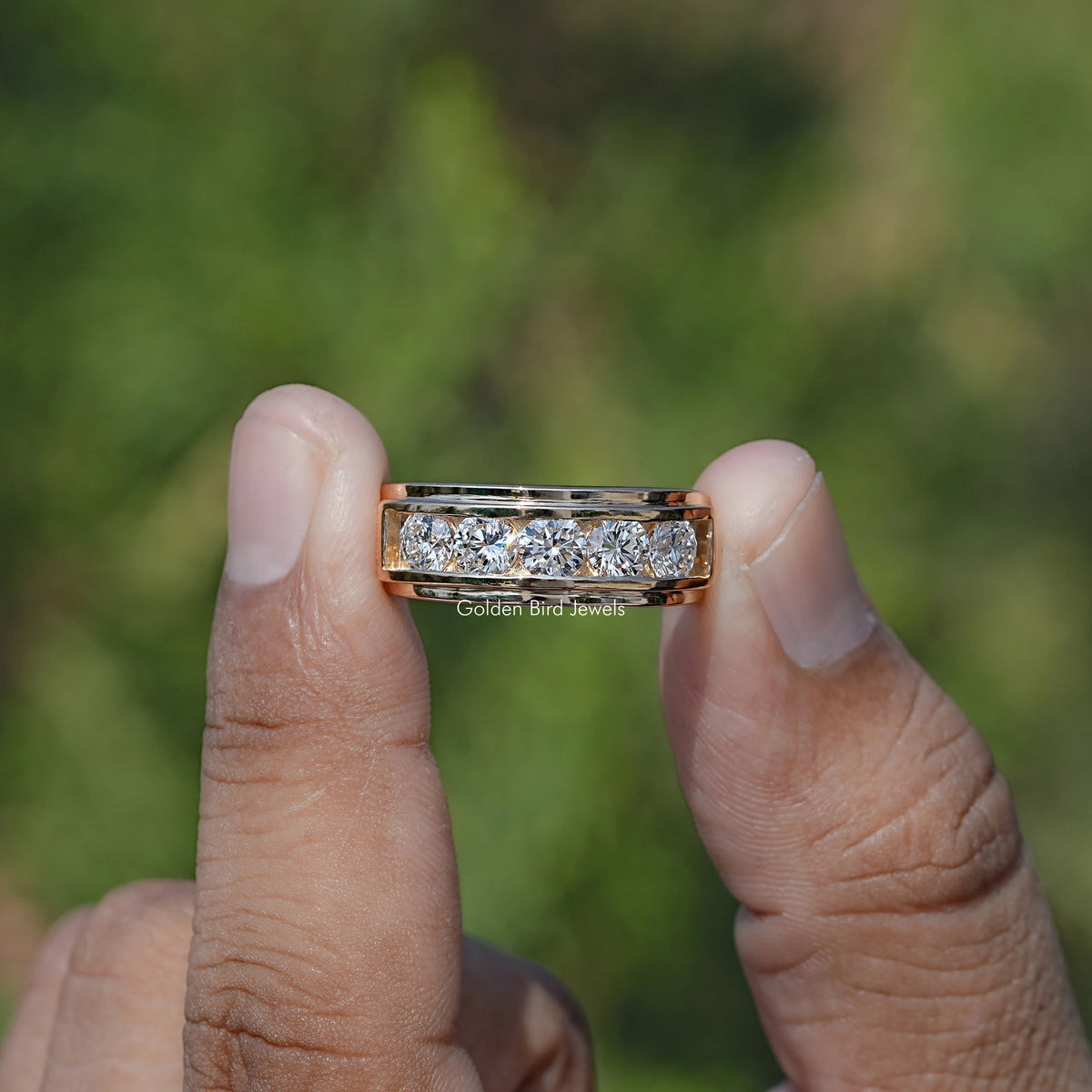 Front view of Lab Diamond Channel Set Men's Ring holding in two fingers 