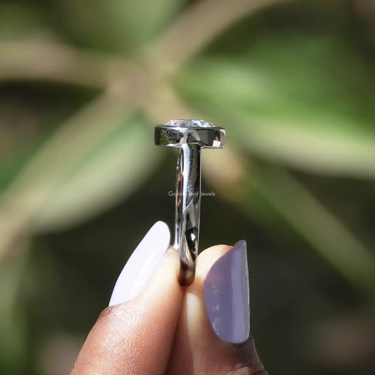 Side View of Round Cut Moissanite Engagement Ring In finger