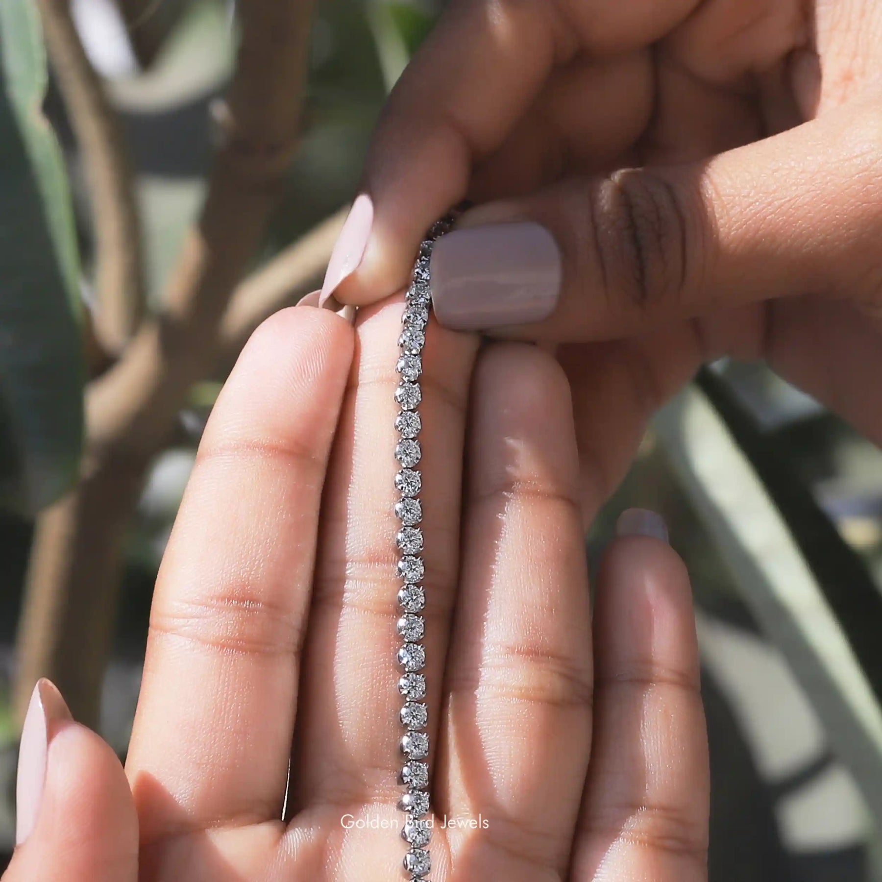 View of moissanite round bracelet for women in secure setting 
