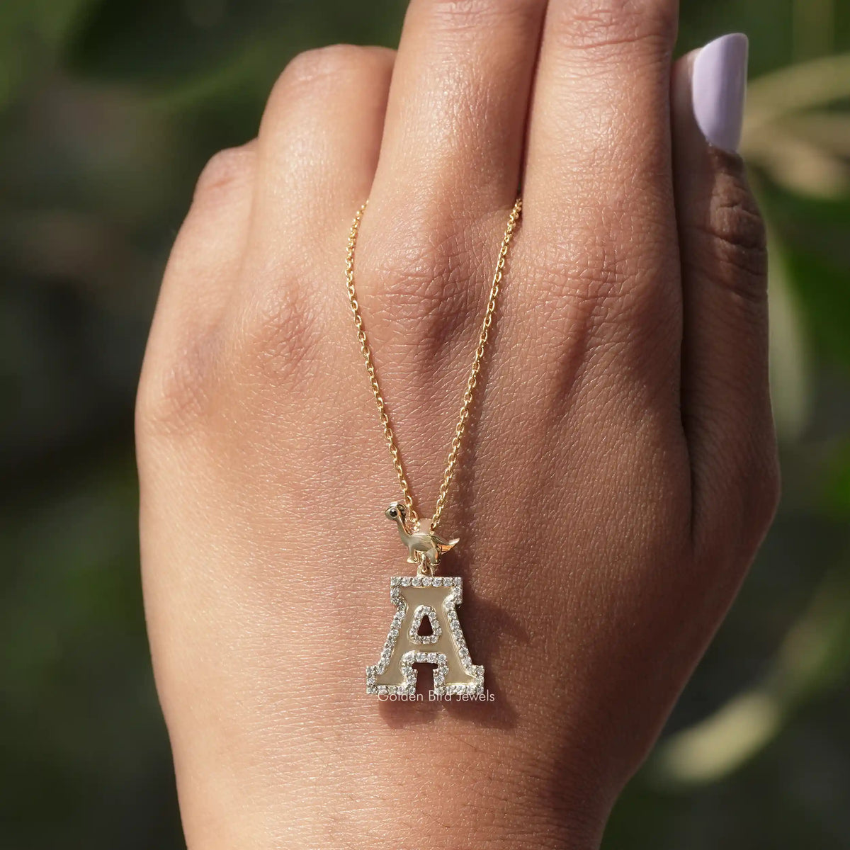 In hand showing view of moissanite pendant	 		