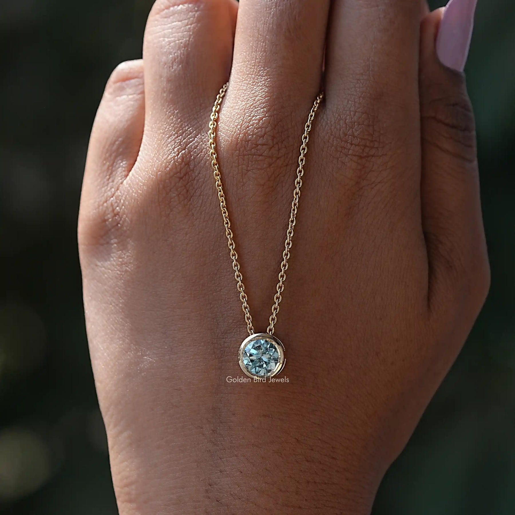 In hand showing view of moissanite pendant	 		