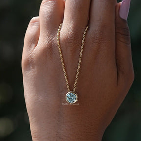 In hand showing view of moissanite pendant	 		