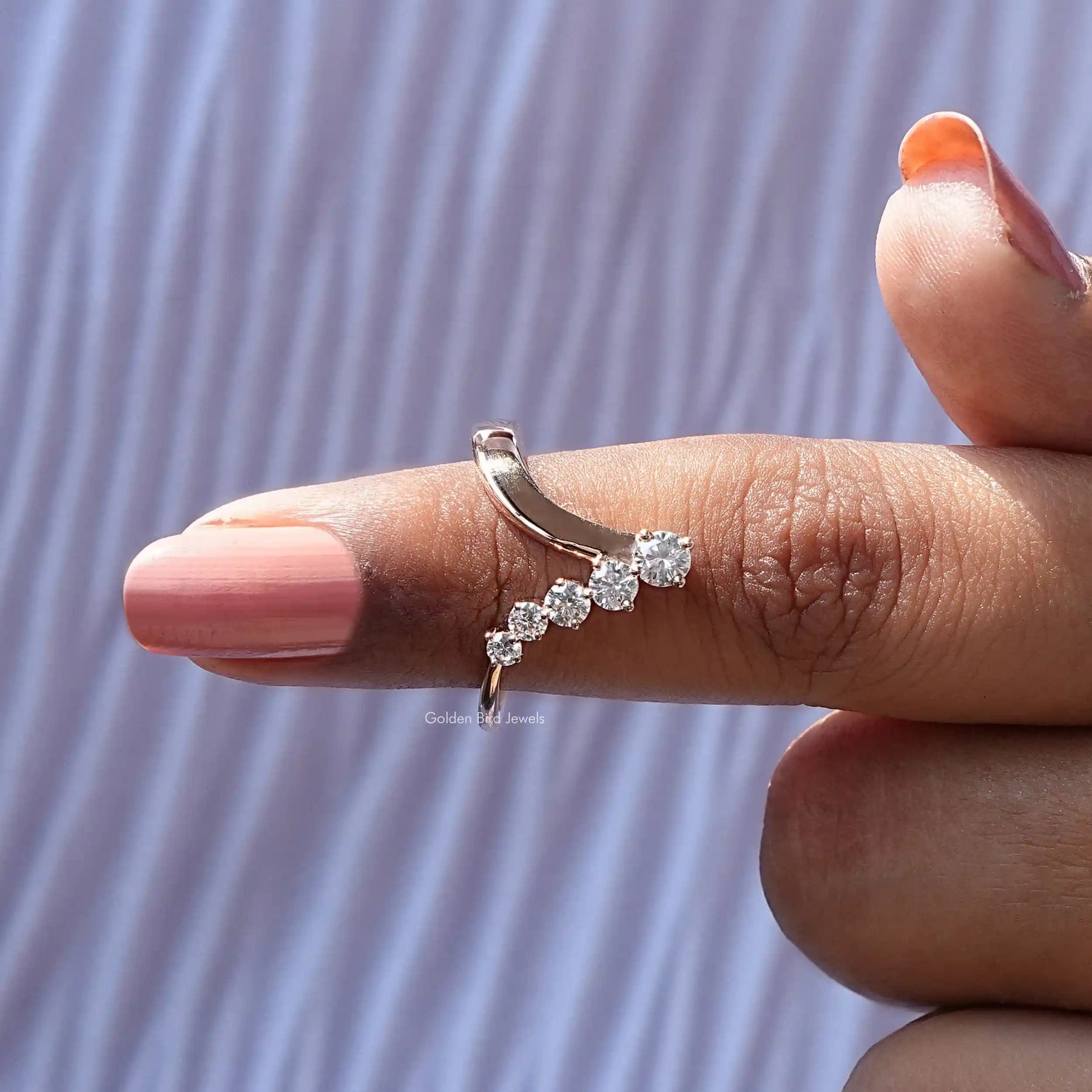 In finger front View of Round Cut V Shaped Moissanite Ring In Yellow Gold
