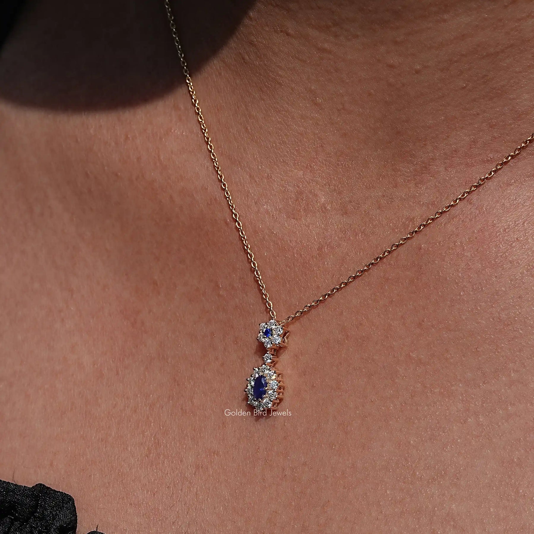 Clear view of Sapphire Blue Oval Cut Gemstone Halo Pendant in wear women' s