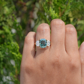 Top View Of Elongated Green Cushion Cut Moissanite Three Stone Ring in prongs setting 