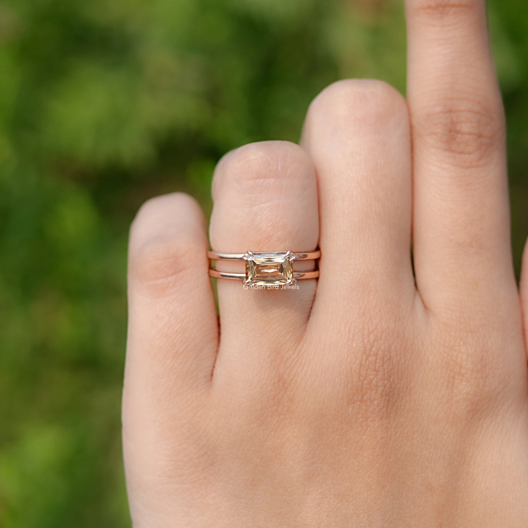 In finger front view of East West Criss Cut Moissanite engagement ring 