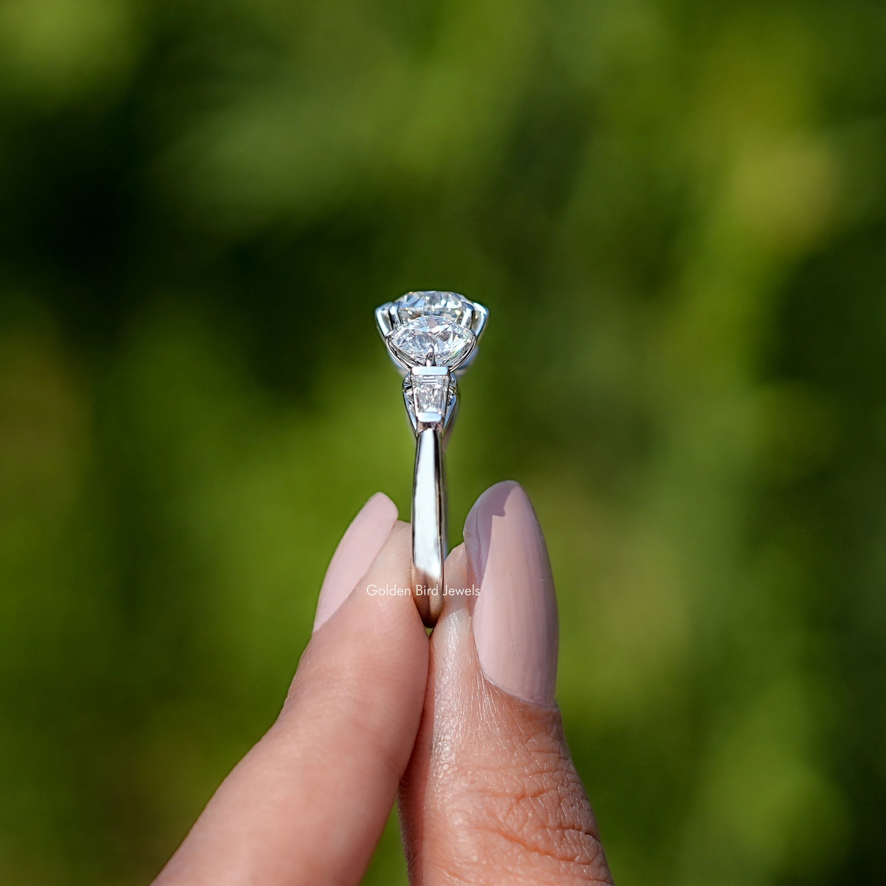 Side View of Old European Round Cut Lab Diamond Five Stone Ring In two fingers