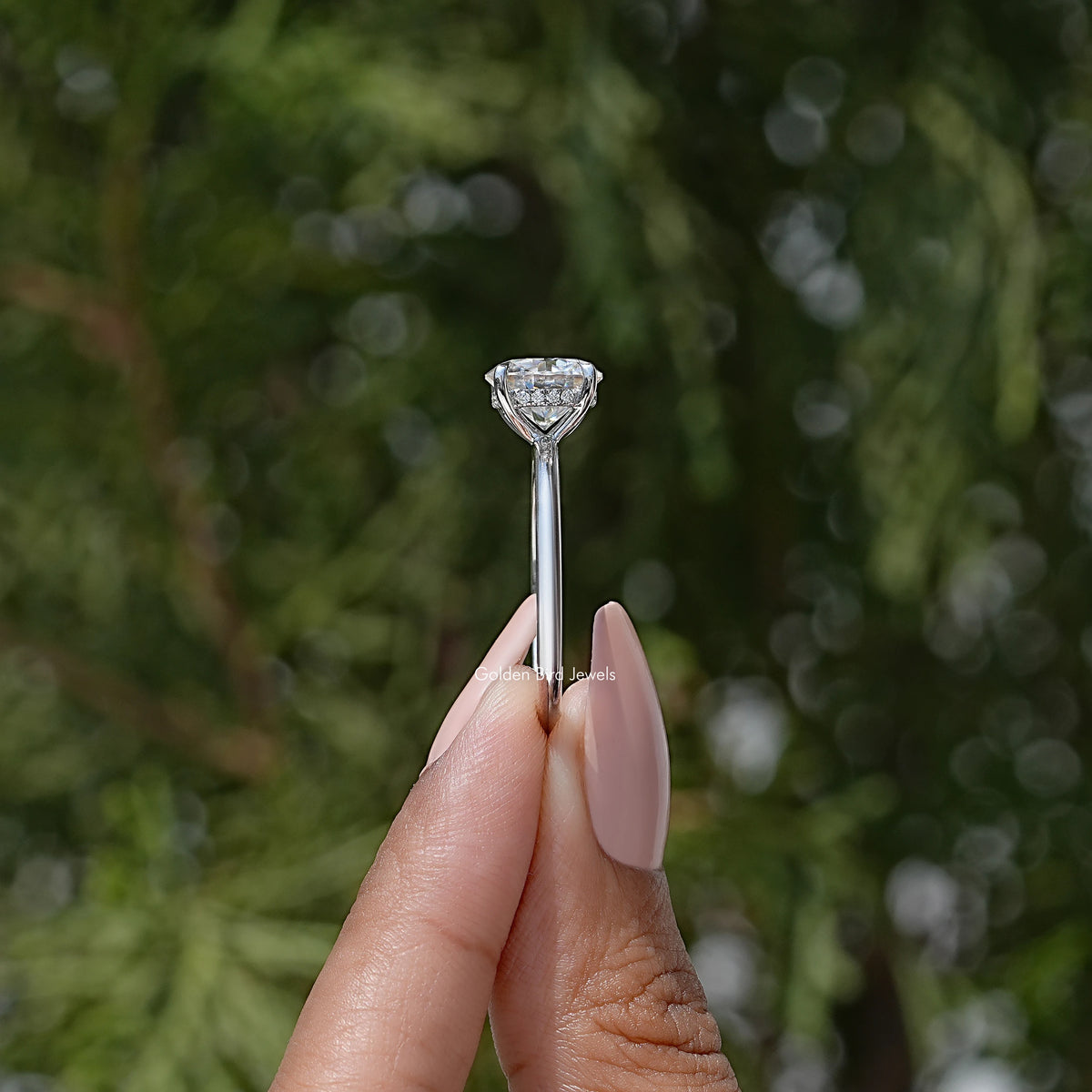 Round solitaire engagement ring top view with four prongs holding a clear round center stone