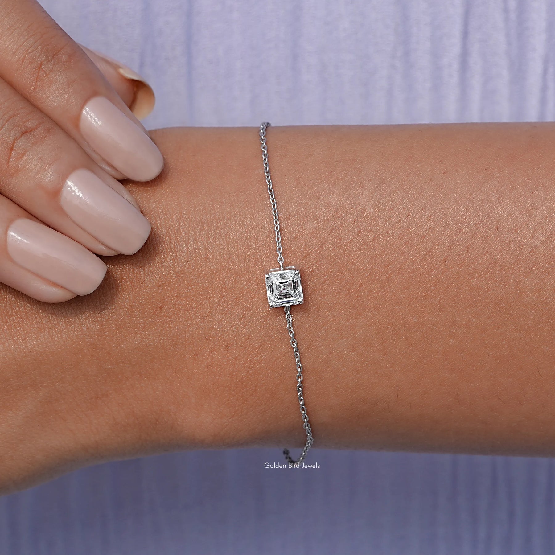 In hand view of diamond  delicate chain bracelet 