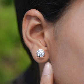 View of Round Cut Diamond Bezel Set Stud Earrings In Ear's