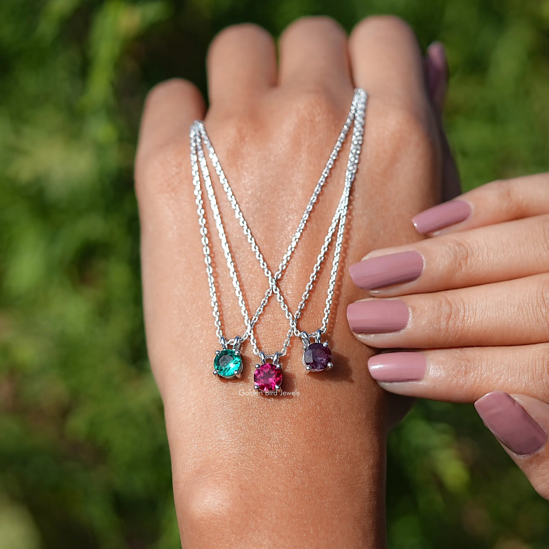 Hand holding the Round Cut Gemstone Solitaire Pendant