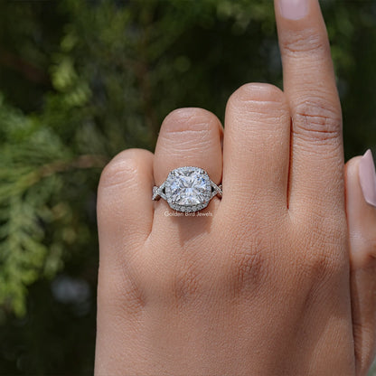 Twisted halo engagement ring with round lab diamond center stone and side accents