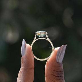 Back View of Blue Green Oval Cut Moissanite Ring In two fingers