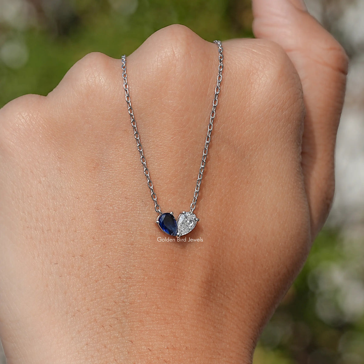 Sterling silver two-stone pendant necklace with pear-cut blue and clear stones