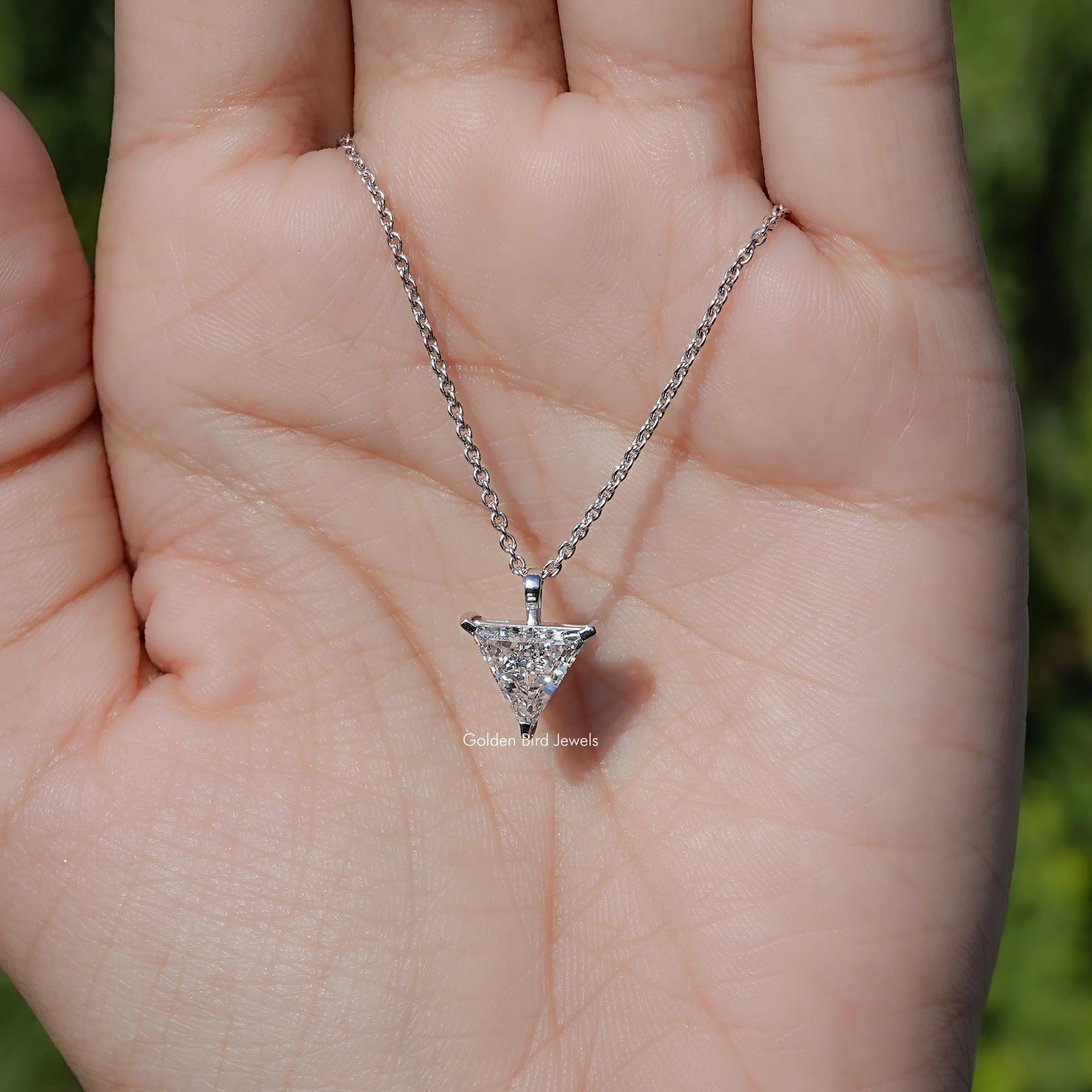 In Hand Showing View Of Lab Diamond Solitaire Necklace 
