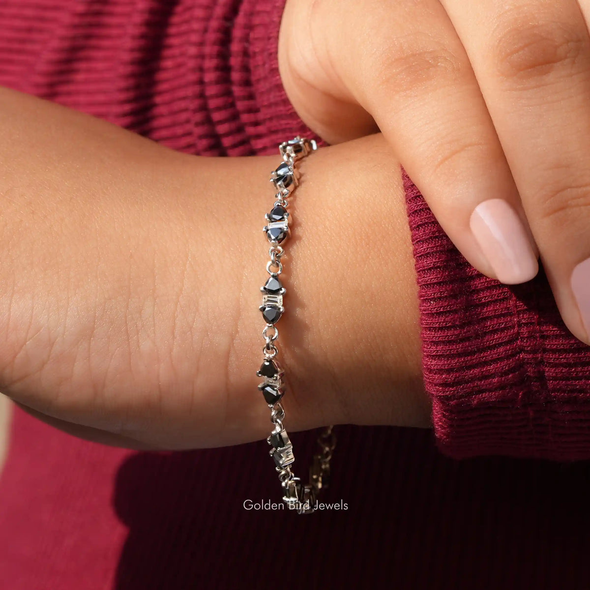 In hand view of trillion cut moissanite halo bracelet 