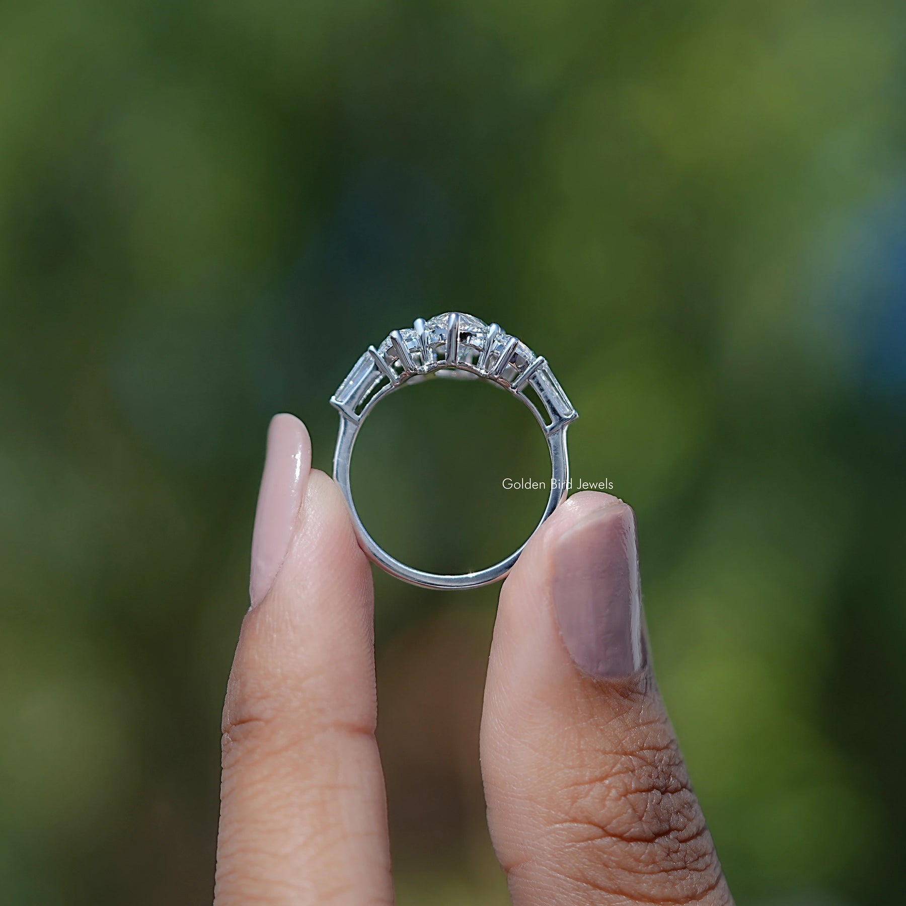 Back View of Marquise Cut Diamond Five Stone Ring In two fingers