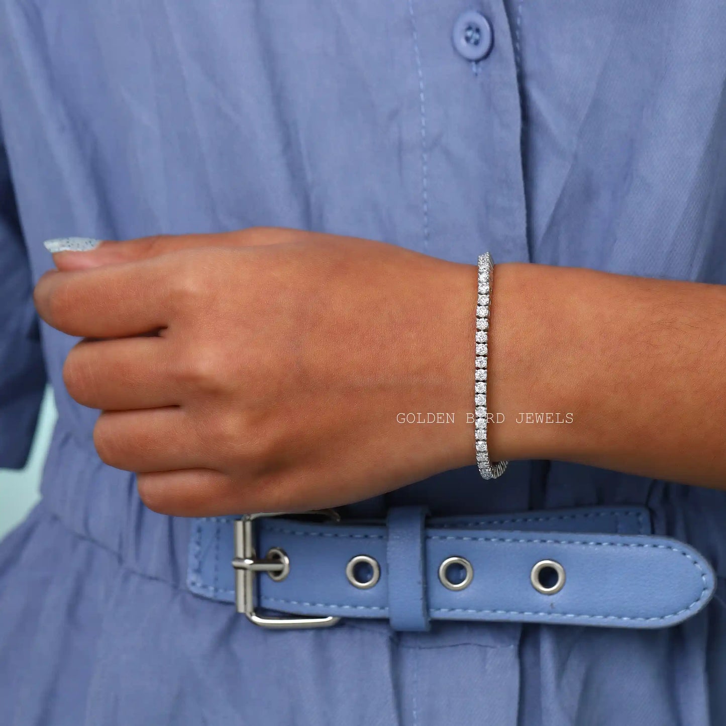 On hand front view of round cut moissanite bracelet made in prong setting 