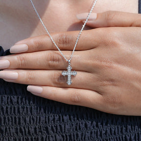 In Hand Showing View Of Round Cut Moissanite Encrusted Cross Pendant
