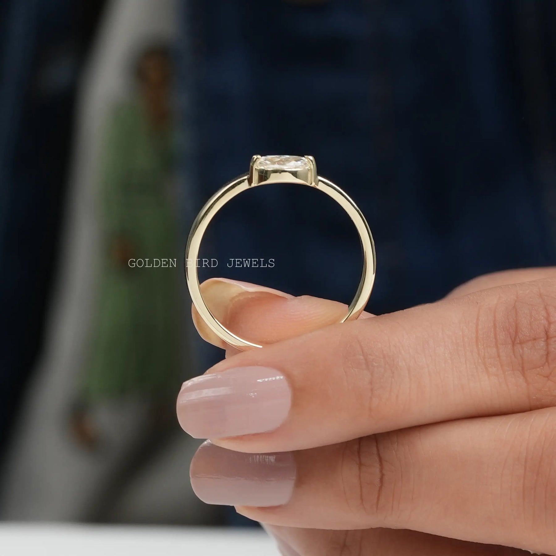 Back View of Moissanite Marquise Cut Engagement Ring In two fingers