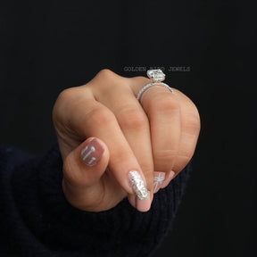 In Finger View Of Emerald And Round Cut Moissanite Solitaire Engagement Ring