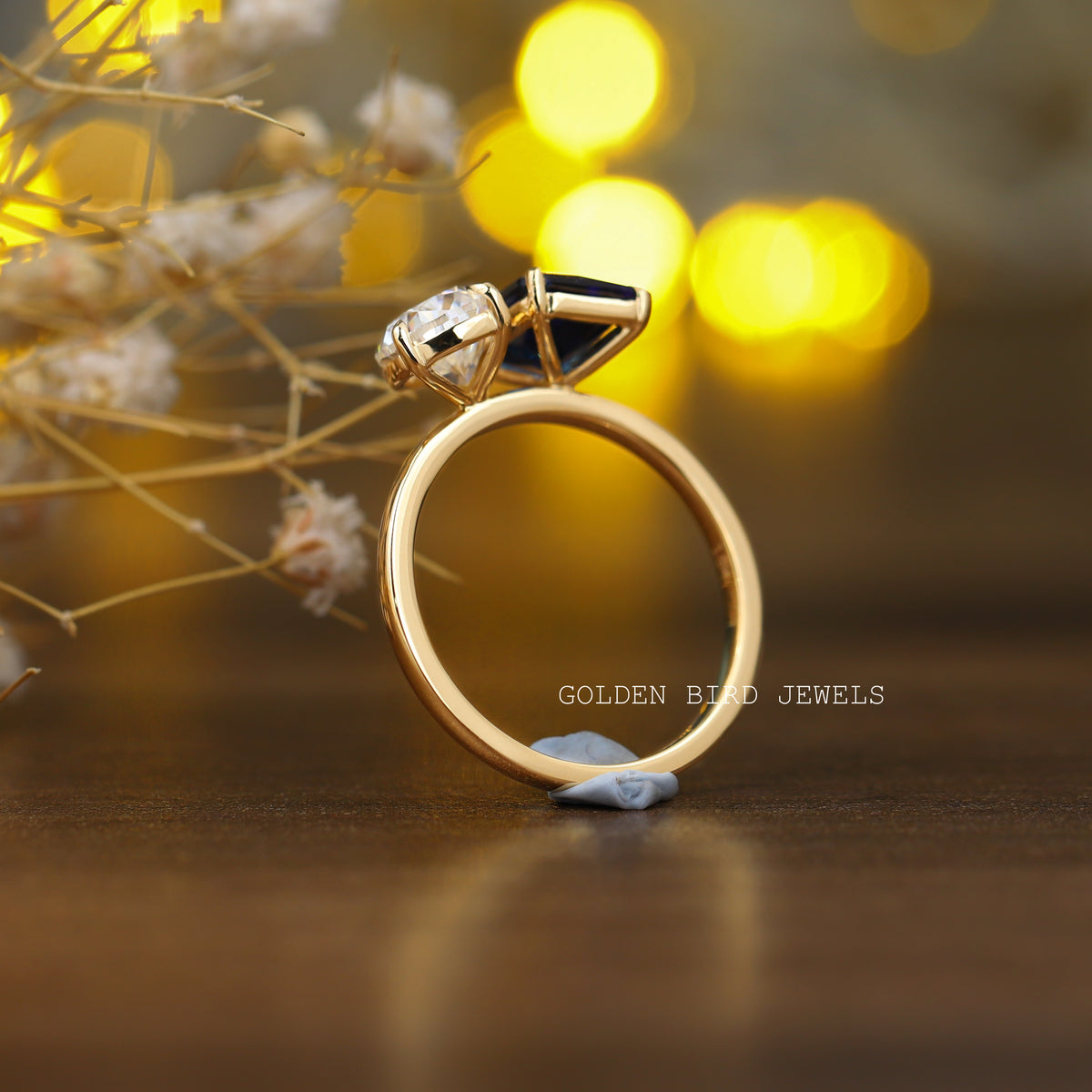 Back View of Emerald And Pear Cut Toi Moi Ring In two fingers