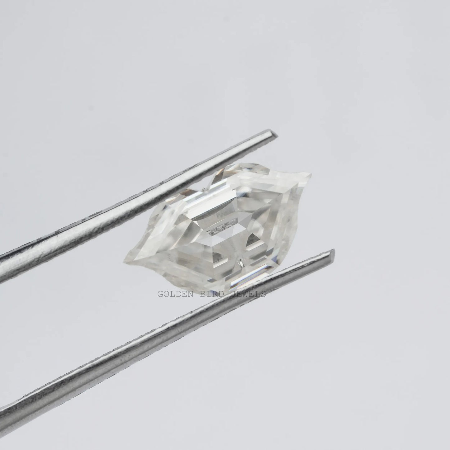 Front view of the tweezer Holding Antique Lips Loose Moissanite Stone In White color 
